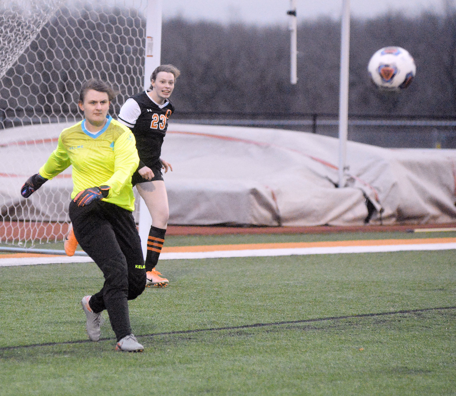 Loyd is also shown delivering a goal kick with teammate Kiana Guerrero watching the flight path of the ball.